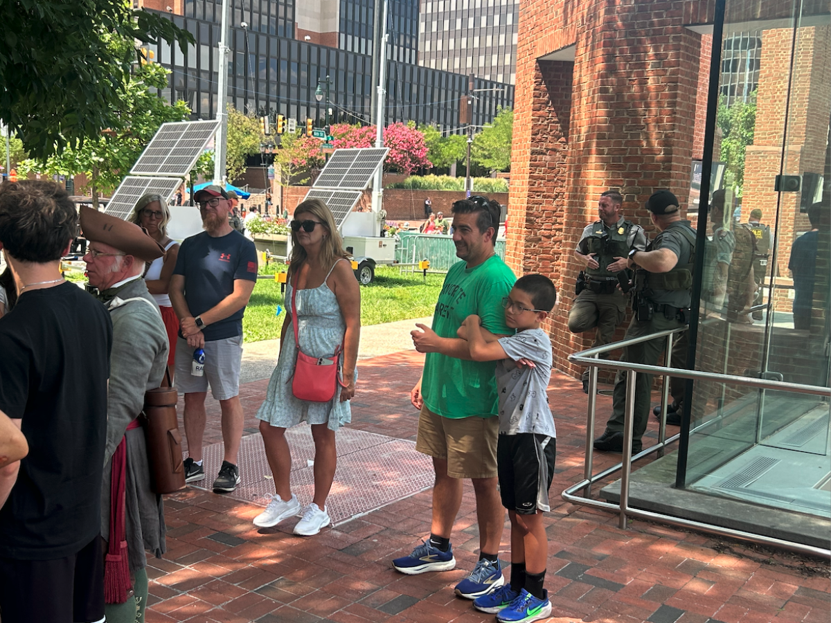 Three Fed Park Police guard President's House Exhibit in Philadelphia as tour guide in period costume holds forth to crowd